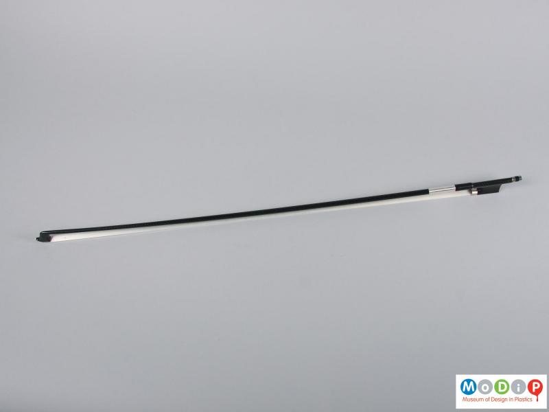 Top view of a violin bow showing the full length.