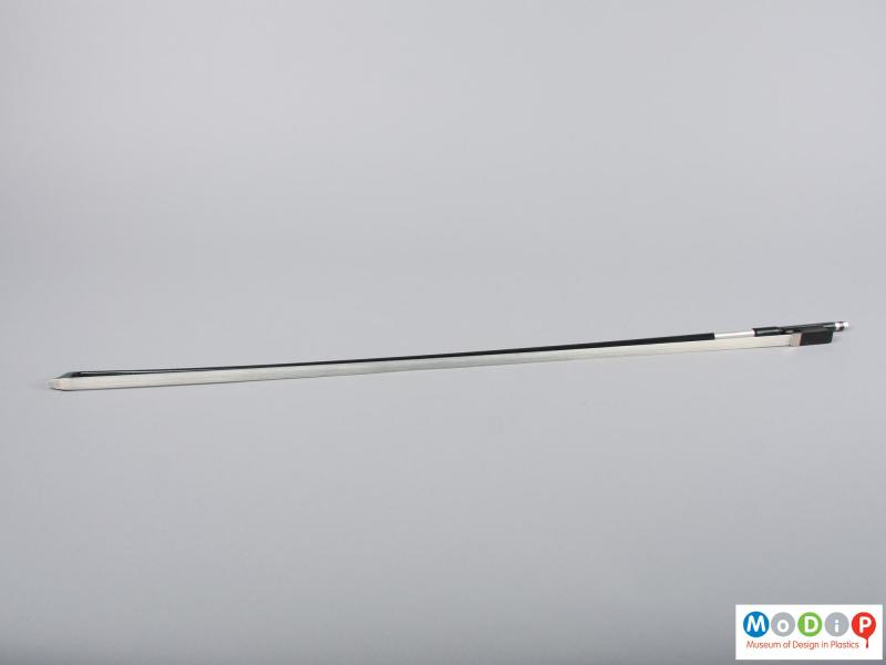 Underside view of a violin bow showing the hair.