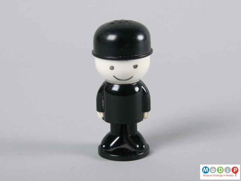 Front view of a pepper shaker showing the suited male figure.