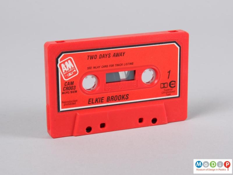 Side view of a cassette tape showing the red body.