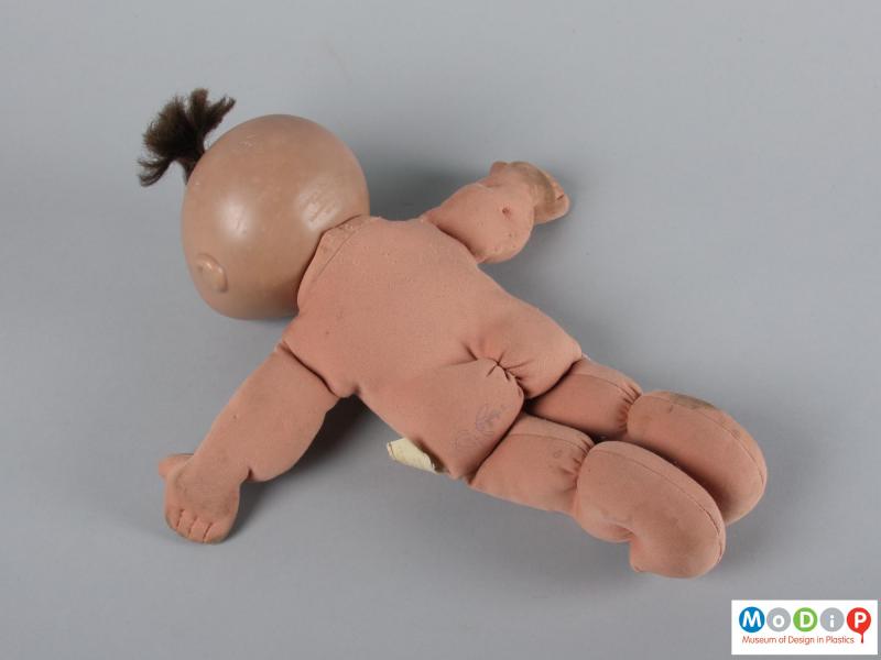 Rear view of a doll showing it unclothed.