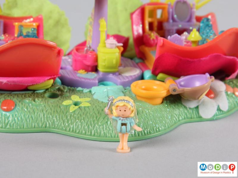 Close view of a Polly Pocket toy showing the small doll.