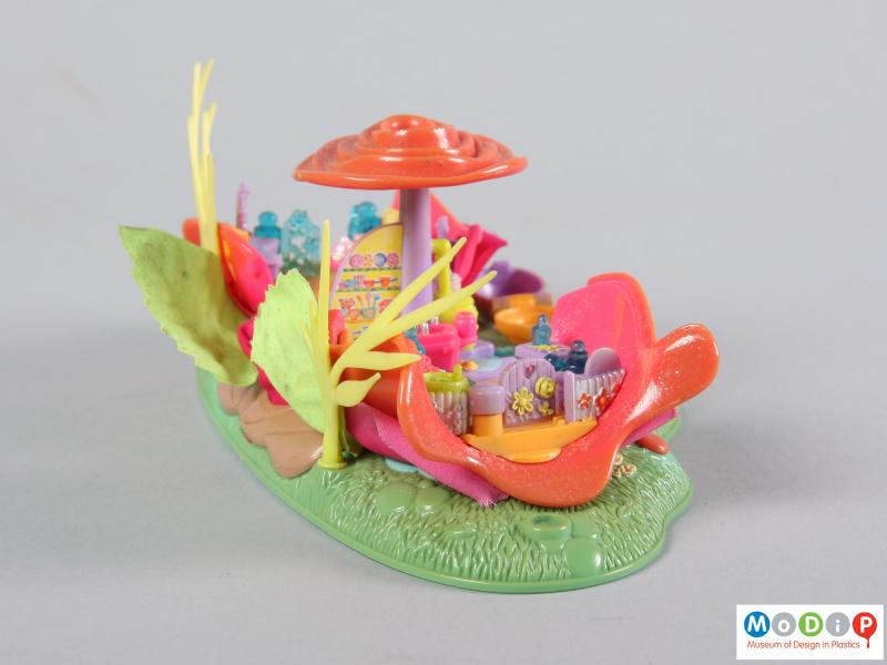 Side view of a Polly Pocket toy showing the garden gate.