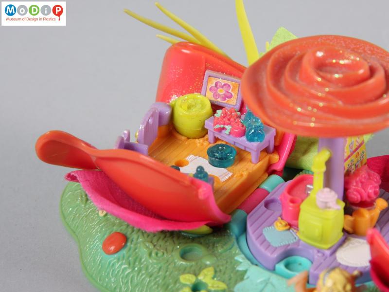 Close view of a Polly Pocket toy showing a living room setting.