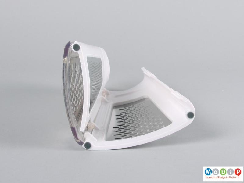 Underside view of a grater showing folding mechanism.