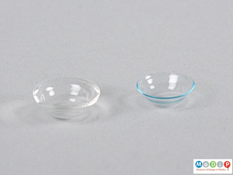 Side view of a pair of contact lenses showing the curved surface.
