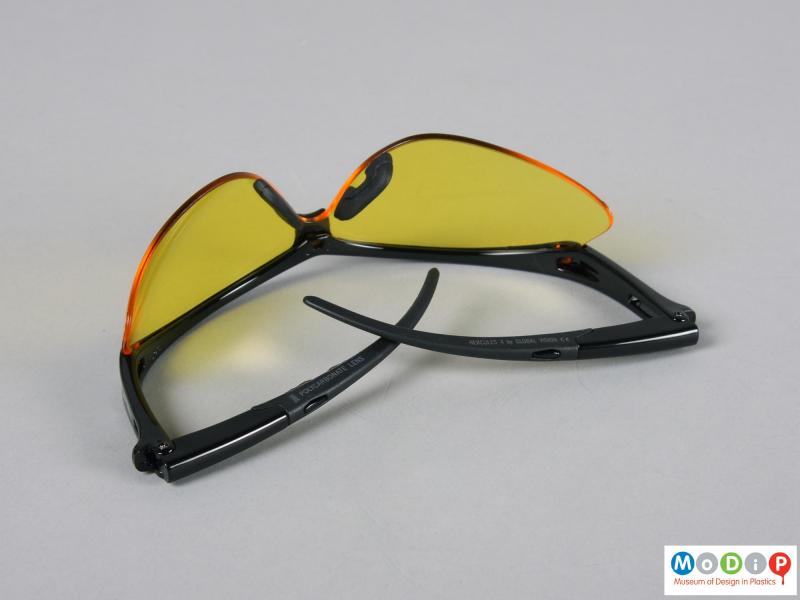 Underside view of a pair of glasses showing the folded arms.