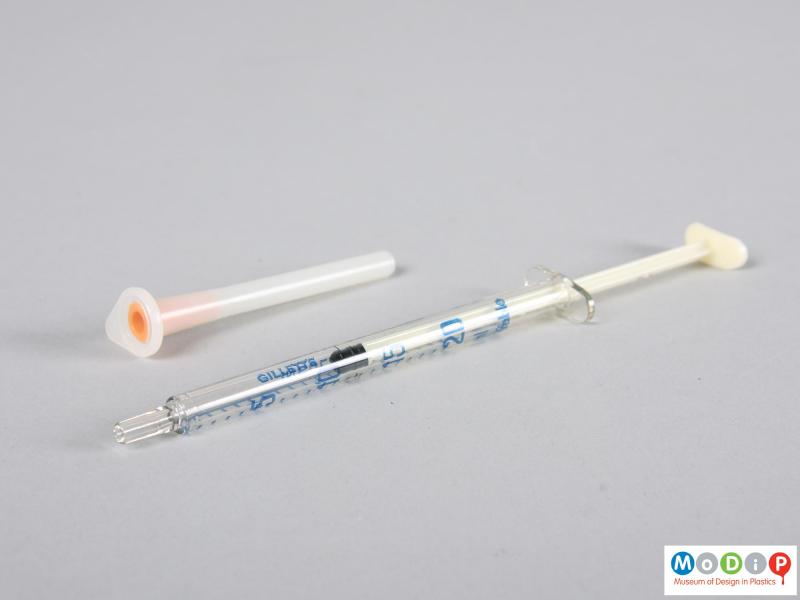 Side view of a syringe showing the plunger pulled back.