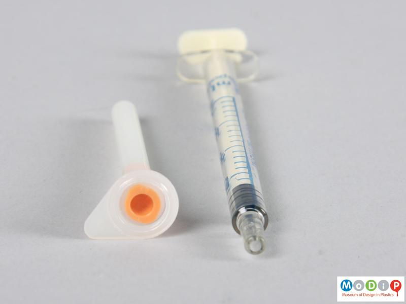 Side view of a syringe showing the needle housing.