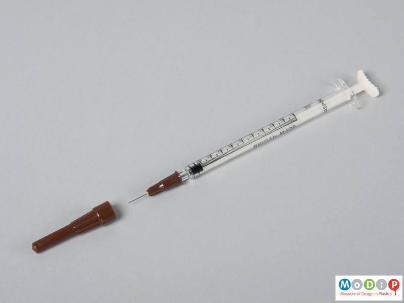 Side view of a syringe showing the needle.