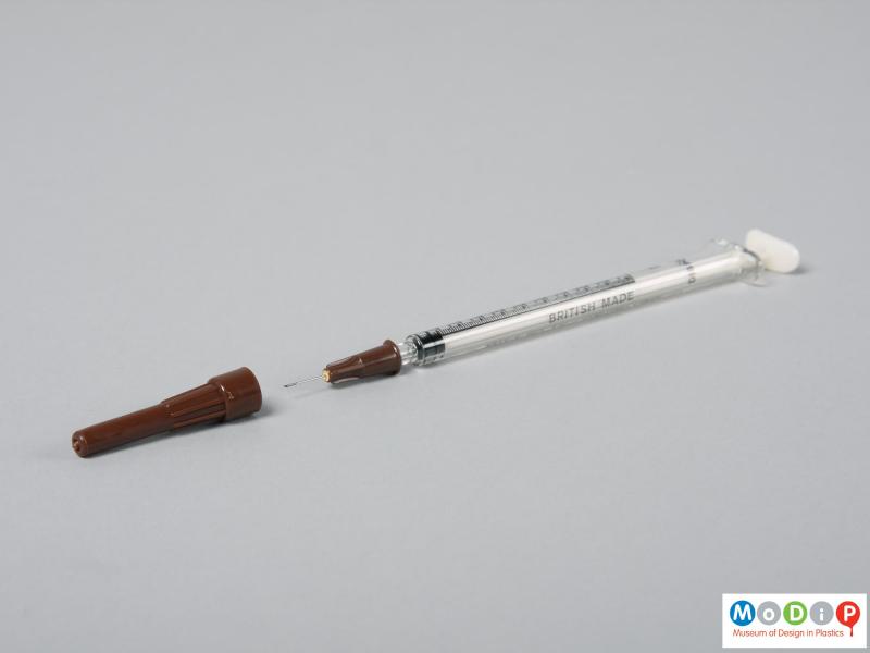 Side view of a syringe showing the needle.