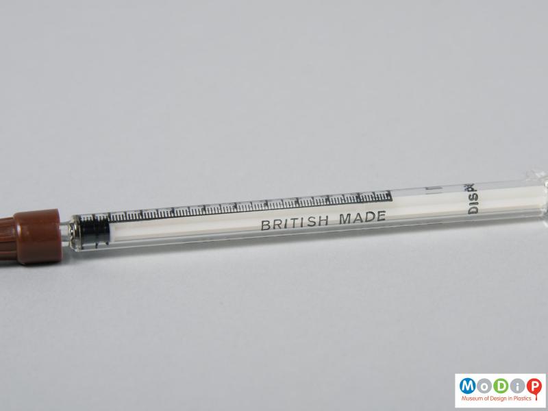 Close view of a syringe showing the printed demarcations.