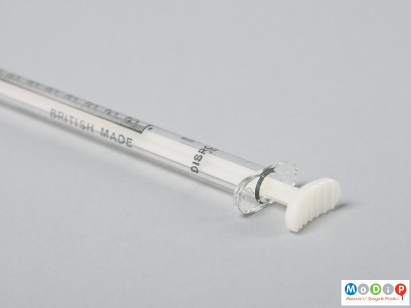 Close view of a syringe showing the plunger pushed forward.