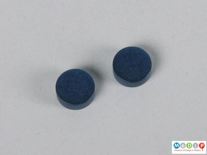 Top view of two blue contact lens buttons showing the surface.