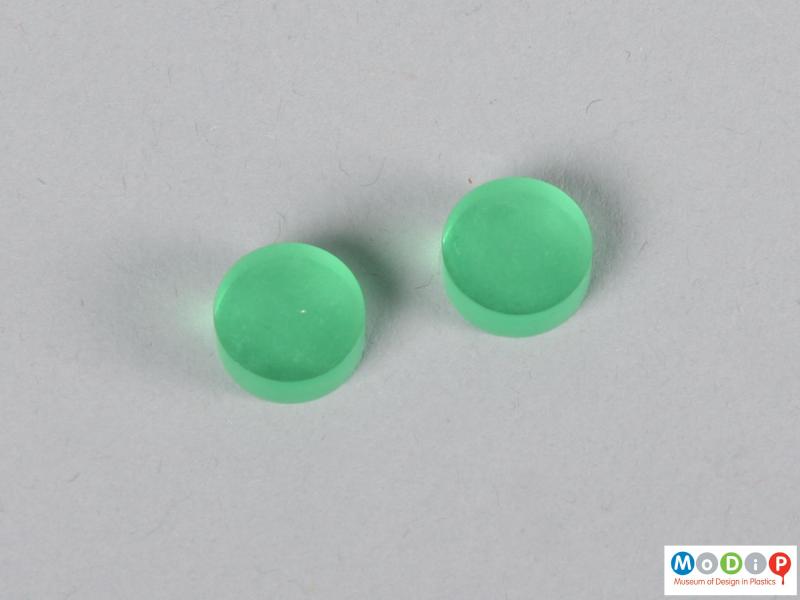 Top view of two blue contact lens buttons showing the surface.