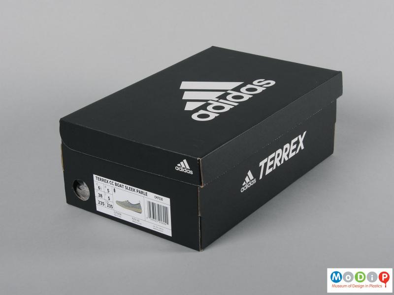 Side view of a pair of shoes showing the packaging.