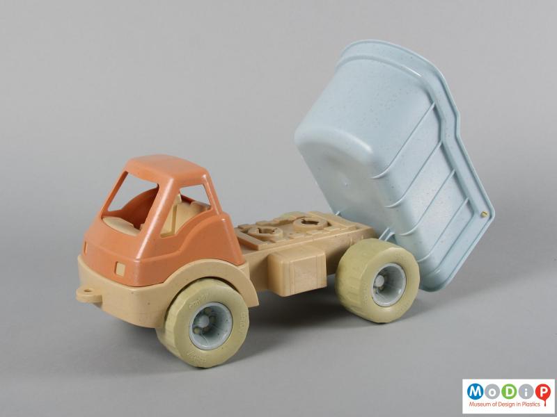 Side view of a toy truck showing the container tipping.