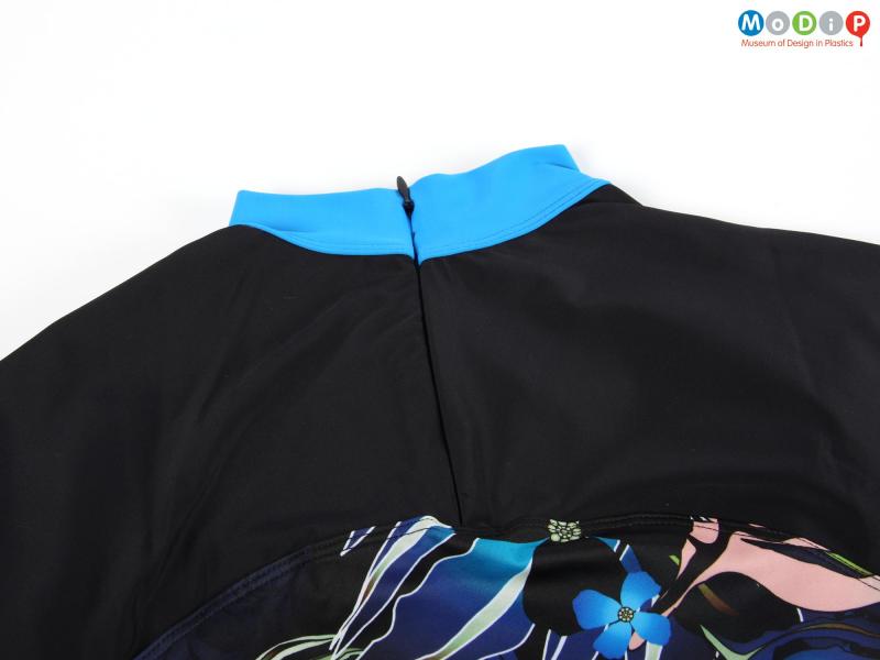 Close view of a rash guard showing the closed zip.