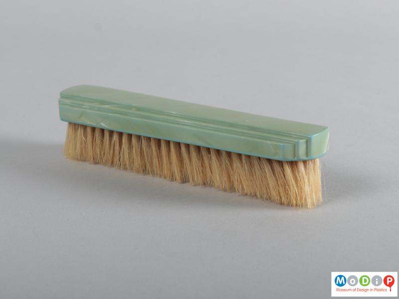Side view of a brush showing the stepped design on the top.