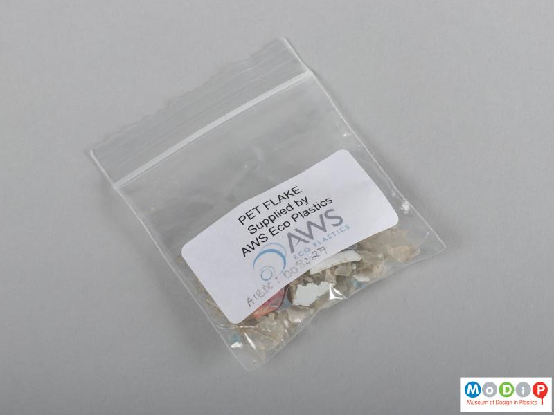 Side view of a PET flakes sample showing the packaging.
