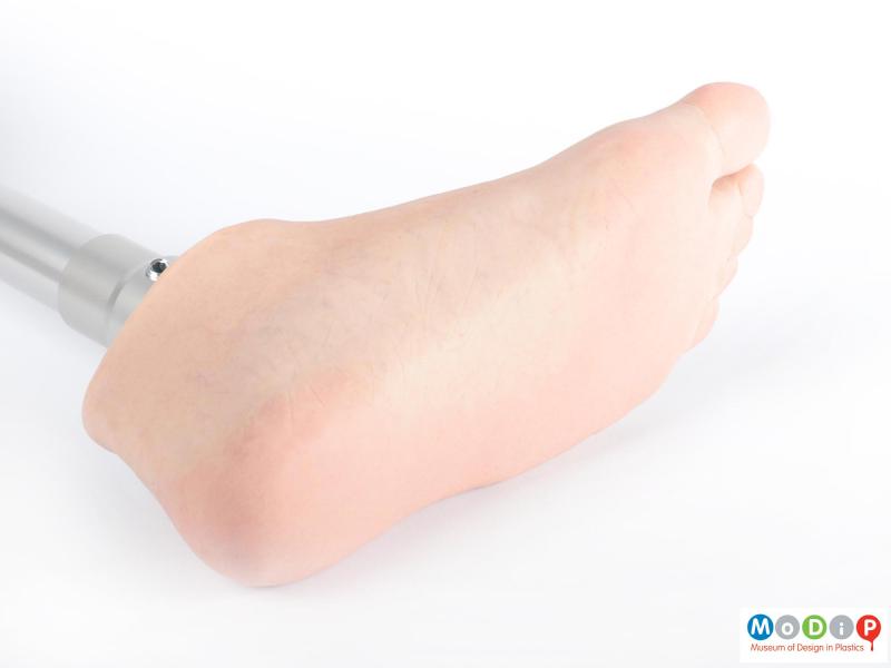 Close view of a prosthetic leg showing the underside of the silicone foot.