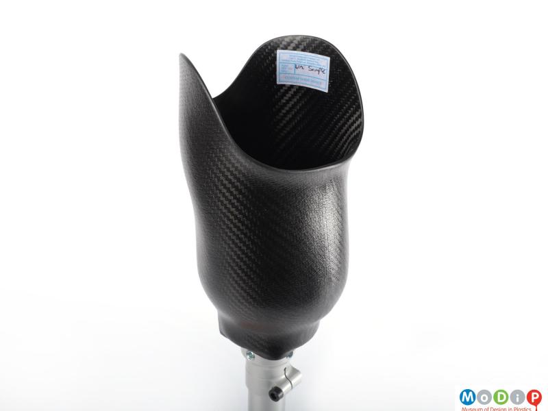 Close view of a prosthetic leg showing the rear of the carbon fibre composite cup.