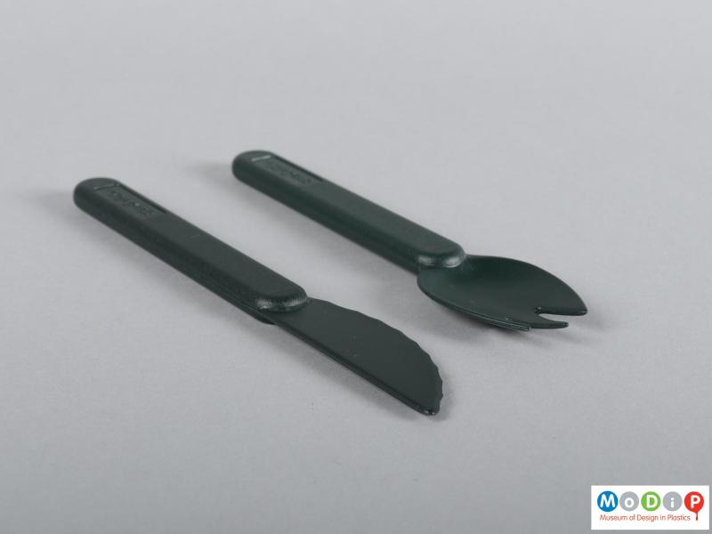 Side view of a cutlery set showing the slight curve in the bowl of the fork.