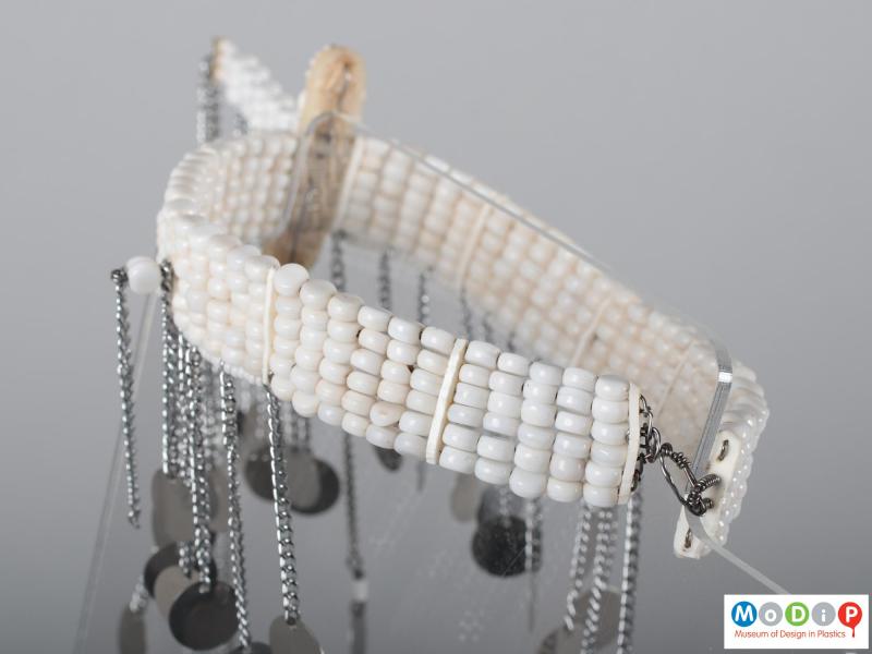 Close view of an armlet showing the white beads.