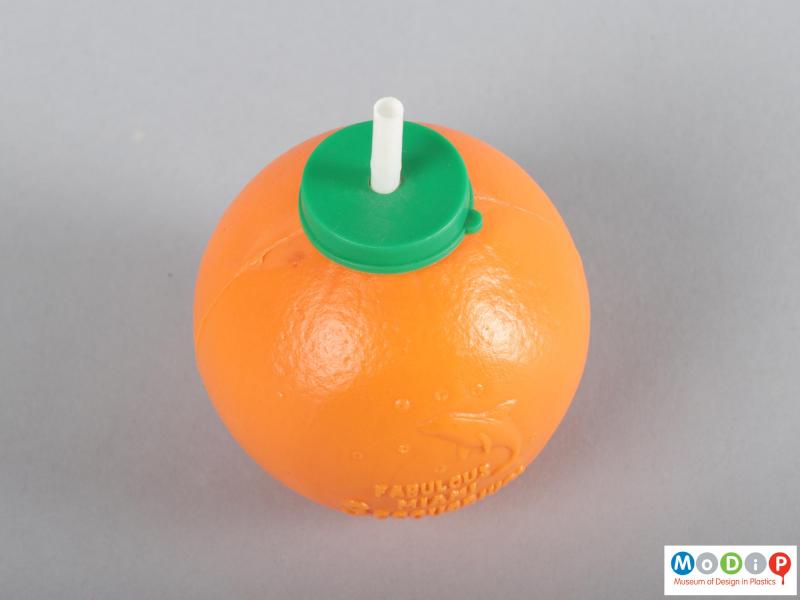 Top view of an orange drink container showing the lid and straw.