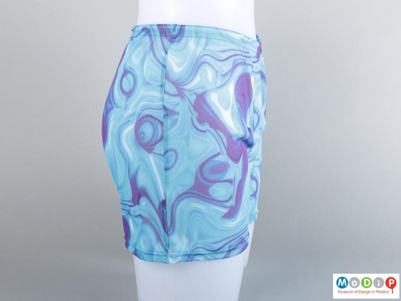 Side view of a pair of swim shorts showing the sewn side seam.