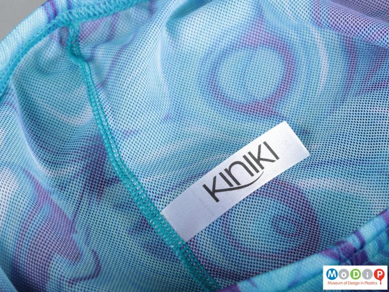 Close view of a pair of swim shorts showing the label.
