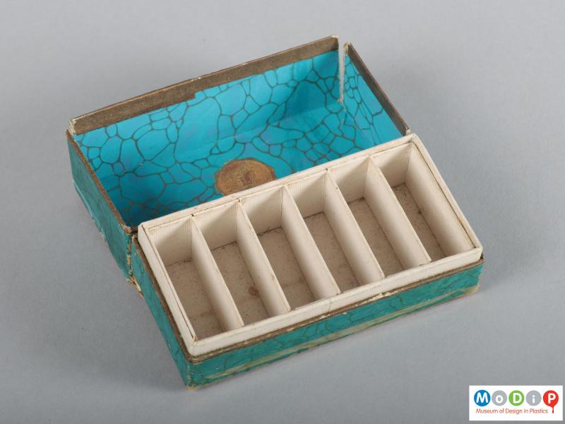Top view of a box of napkin rings showing the open and empty box.