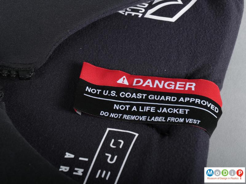 Close view of an impact vest showing the safety label.