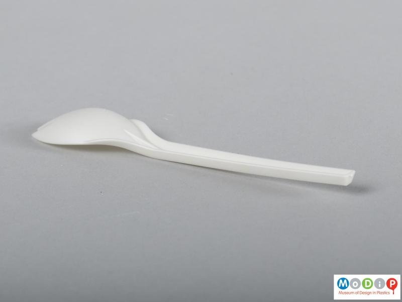 Side view of a spork showing the straight and tapered handle.