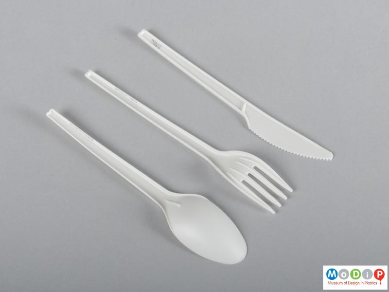Underside view of a cutlery set showing the straight and tapered handles.