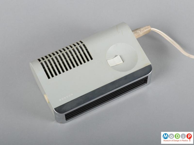 Side view of a hairdryer showing the air intake grill and the on / off switch.