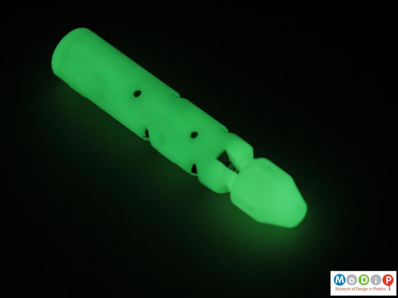 Side view of a fishing weight showing that it glows in the dark.