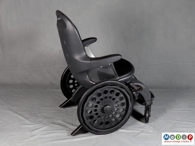 Side view of a wheelchair showing the large rear wheels.