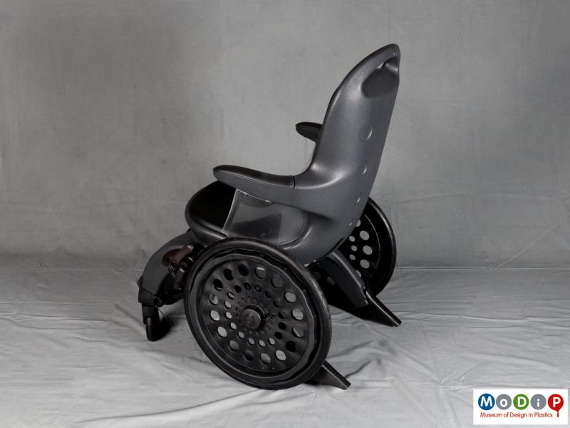 Side view of a wheelchair showing the large rear wheels.