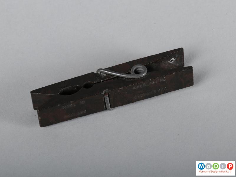 Side view of a clothes peg showing the metal spring.