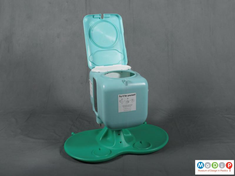 Top view of a handwash stand showing the water and soap dispenser with the lid open.