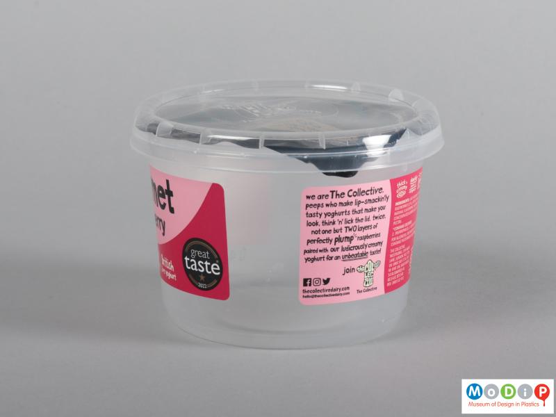 Side view of a yogurt pot showing the clear pot and lid.