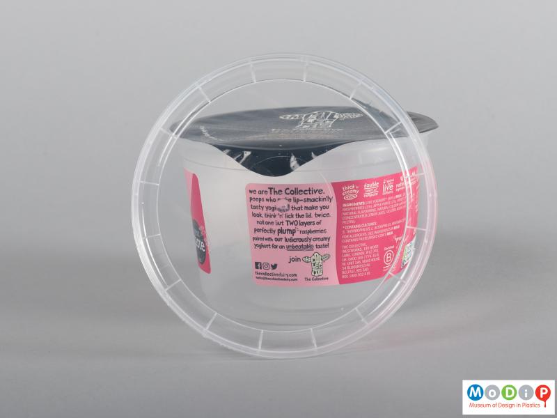 Underside view of a yogurt pot showing the inner surface of the clear lid.