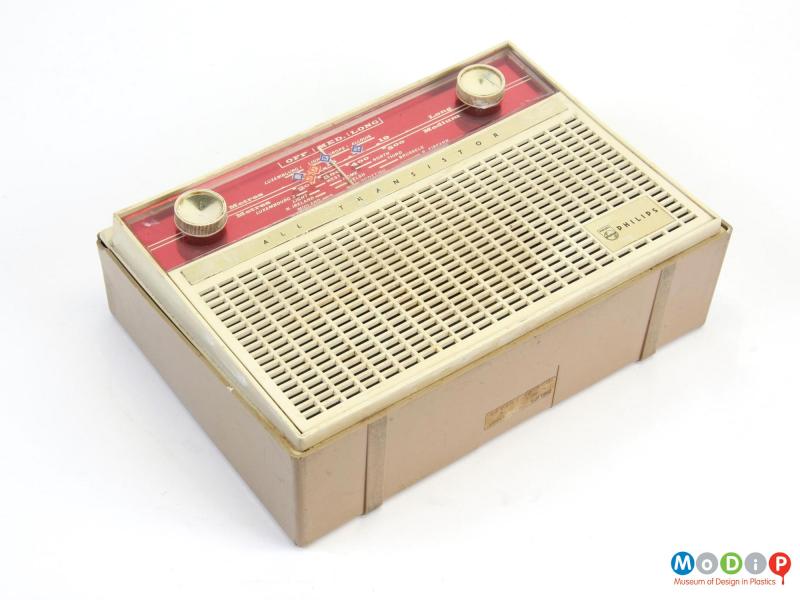 Front view of a Philips L3G03T transistor radio, laying on its back, showing two round dials and a rectangular grill on the front.