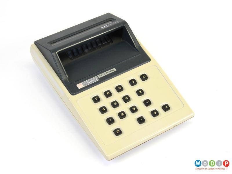 Top view of a Sharp EL-8001 calculator showing the screen shade, the square buttons and the paper feeder on the top.