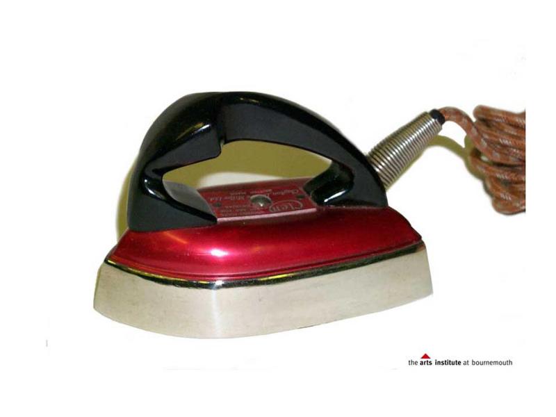 Side view of a travel iron showing it on the heatproof stand.