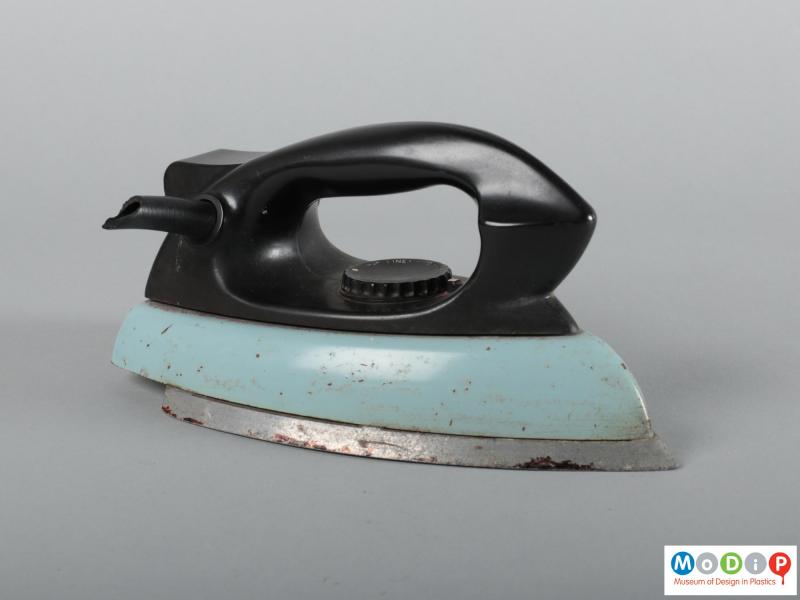 Side view of an iron showing the large black handle.