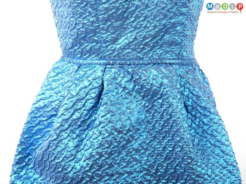 Close view of a dress showing the rippled texture of the material.