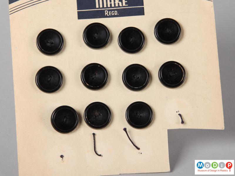 Close front view of an Excelsior button card showing four columns of buttons.