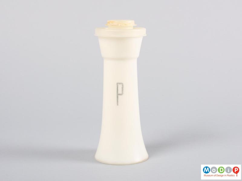 Side view of a pepper shaker showing the printed letter.